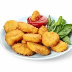 plate-with-chicken-nuggets-ketchup-basil-isolated-white-background_185193-17427